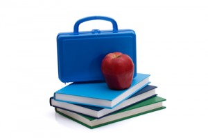 A blue lunchbox with an apple and books isolated on white, Healthy School Lunch