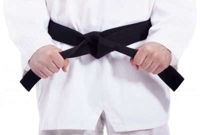 bigstock-Martial-arts-man-tying-his-bla-47307487