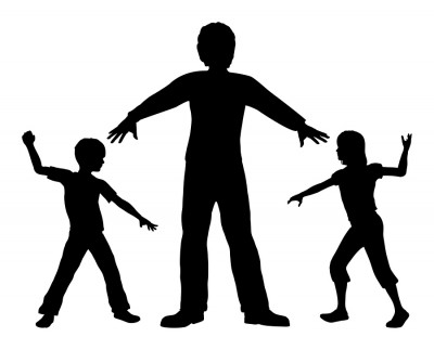 children standing over another child in fear