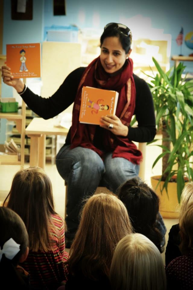 Dhillon reading a book to students