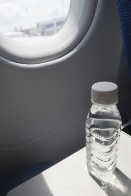 Water bottle on seat tray in an airplane