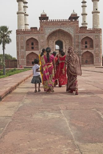 Indian family in brightly colored clothing at the tomb of the Mughal Emperor Akbar in Agra 