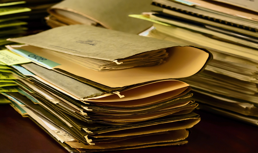 Tax preparation stack of files and paperwork bills and receipts in old vintage files on desk social share image or promotional photography